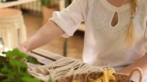Close up of women's hands weaving macrame in a home workshop. Stock Footage 154343500