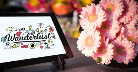 Close-up of wonderful text on device screen on tablet computer by flowers on Stock Photos