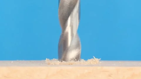 Close-up of a wood drill rotating. The screwdriver chuck holds a sharp, shiny Stock Footage 253111267