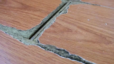 Close-up of wood laminate surface with visible signs of wear and damage, in.. Stock Footage 315093118