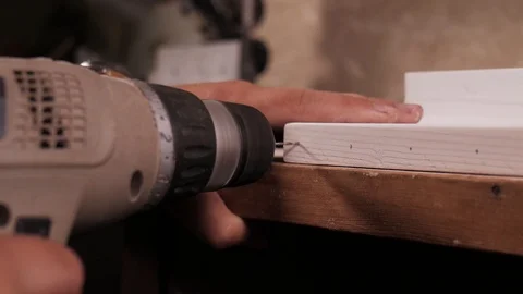 Close up of Wood Worker using an electric hand drill to drill a hole through. Stock Footage 110684569