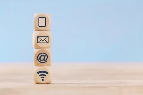 Close up Wooden block cube with communication symbol icon mobile phone, ema.. Stock Photos