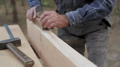 Close-up of a wooden board being processed with a hand plane Video stock 286207159