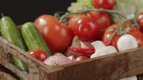 Close-up in wooden box with vegetables drops bunch of green salad Stock Footage 123961690