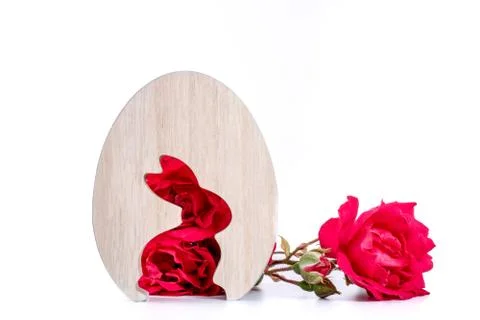 Close-up of wooden easter egg with rabbit shape of rose flowers in background Stock Photos