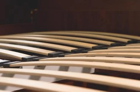 Close-up wooden elements of an arthopedic base of a double bed. Interior 스톡 사진