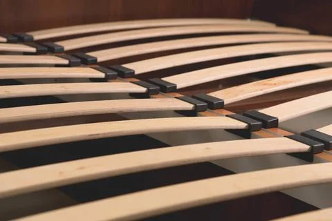 Close-up wooden elements of an arthopedic base of a double bed. Interior s... Stock Photos