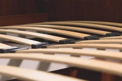 Close-up wooden elements of an arthopedic base of a double bed. Interior s... Stock Photos
