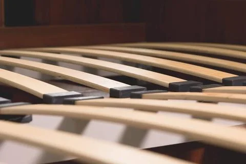 Close-up wooden elements of an arthopedic base of a double bed. Interior s... Stock Photos