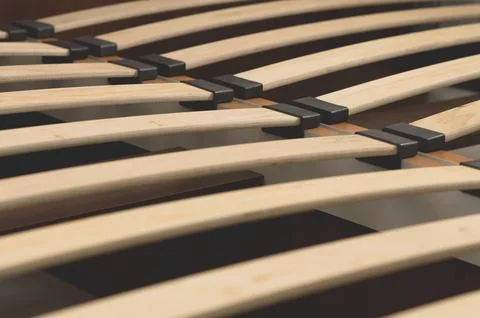 Close-up wooden elements of an arthopedic base of a double bed. Interior 스톡 사진