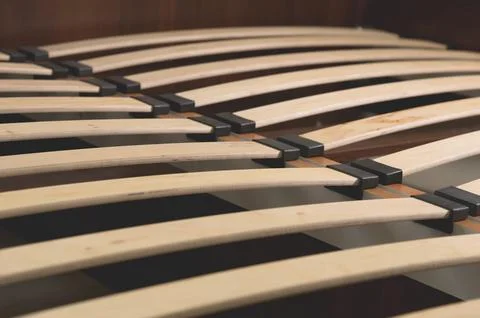 Close-up wooden elements of an arthopedic base of a double bed. Interior Stock Photos