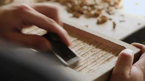 Close up. a woodworker processes the walnut board with a small planer. artisa Stock Footage 144244267