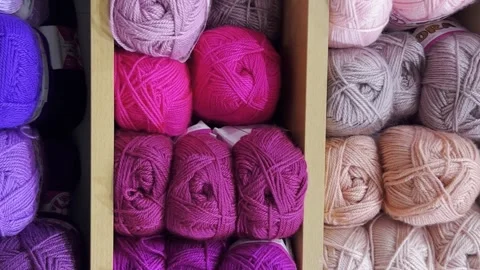 Close-up of woolen threads of different colors in a store on a shelf. Vertical Stock Footage 250112523