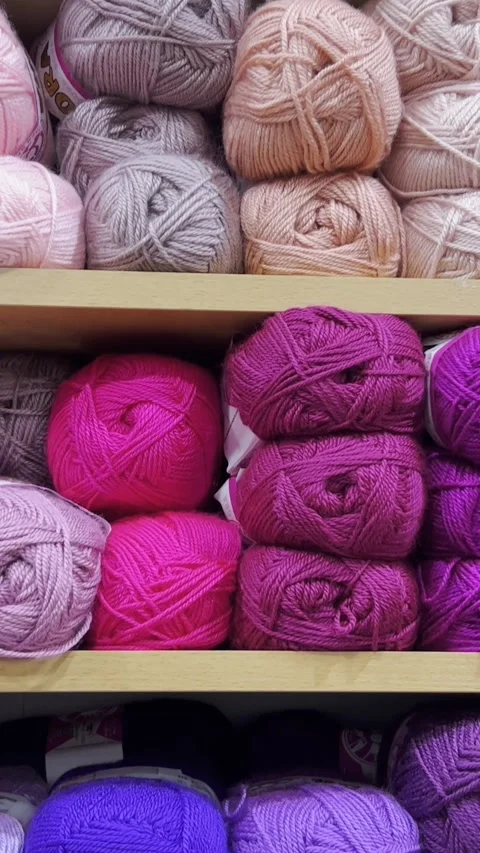 Close-up of woolen threads of different colors in a store on a shelf. Vertical Stock Footage 250385964