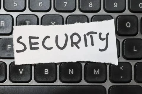 Close-up of the word SECURITY written on a paper strip placed on a laptop Stock Photos