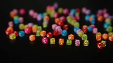 Close-up word "SPRING" collected from colorful cubes with letters on black table Stock Footage 100577268