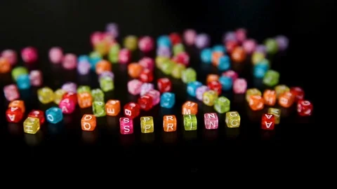 Close-up word "SPRING" collected from colorful cubes with letters on black table Stock Footage 100577270