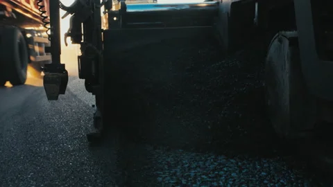 Close up of the work of an asphalt paver. Hot asphalt, bitumen. Asphalt paver Stock Footage 138720378