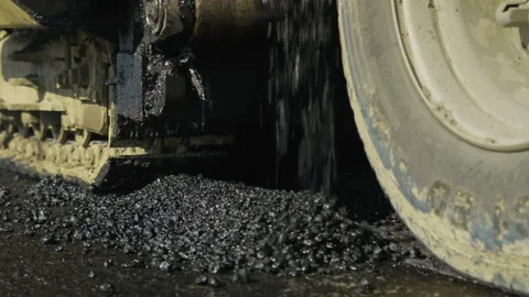 Close up of the work of an asphalt paver. Hot asphalt, bitumen. The asphalt Stock-Footage 140108588