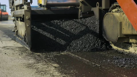 Close-up of the work of an asphalt paver machine. Hot asphalt, bitumen. Asphalt Stock-Footage 140108408