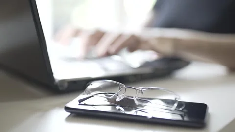 Close-up of the work of female hands at the computer, then the removed glass Stock Footage 241088800