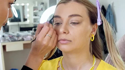 Close-up work of a make-up artist with a model Stock Footage 199425108