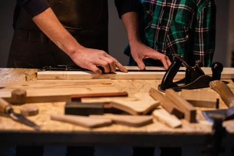 Close-up of the work of a man and a boy at a carpenter's table, on the table are Stock Photos