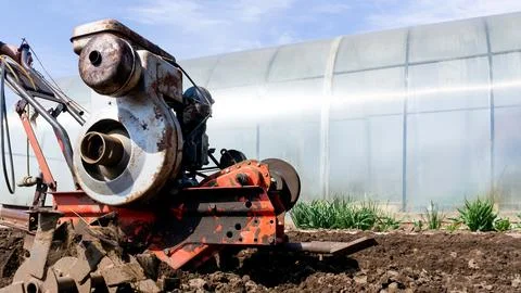 Close-up of the work of a monoblock that plows the earth. The concept of Stock Photos