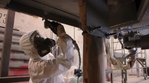 Close-up work painting from a pulverizer with gray paint a metal structure a Stock Footage 196357841