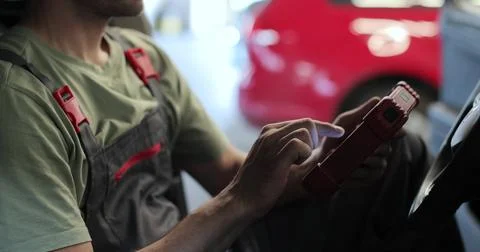Close up work process in the maintenance center. Mechanic is using modern t.. Stock Photos
