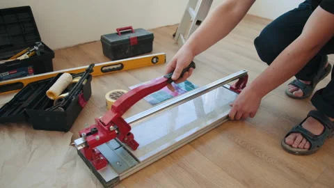 Close-up of a work tool using manual cutting equipment for laying, processing Stock Footage 232164729