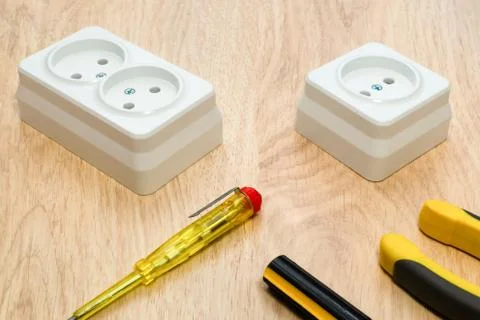 Close-up of work tools and electrical equipment on an wooden desk. Stock Photos