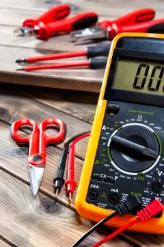 Close up of work tools on electrical installations, on an antique wooden tabl Stock Photos
