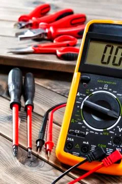 Close up of work tools on electrical installations, on an antique wooden tabl Stock Photos
