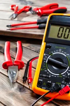 Close up of work tools on electrical installations, on an antique wooden tabl Stock Photos