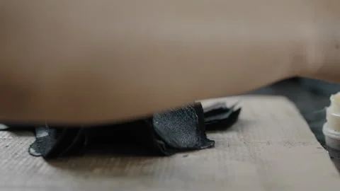 Close Up of Worker Applying Adhesive to Leather Shoe Pieces on Workbench Stock Footage 341667986