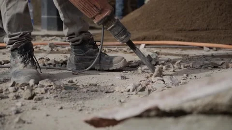 Close up of Worker breaks concrete at a construction Stock Footage 145884564