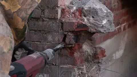 Close-up. Worker breaks the wall with a perforator. Slow motion. Video stock 133294857
