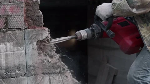 Close-up. Worker breaks the wall with a perforator. Slow motion. Stock Footage 133294941