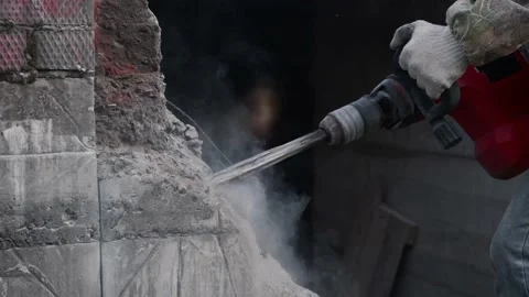 Close-up. Worker breaks the wall with a perforator. Slow motion. Video stock 133294997