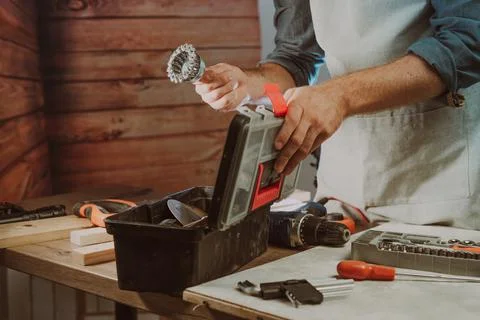 Close up of worker changing a electric brush for screwdriver Stock Photos