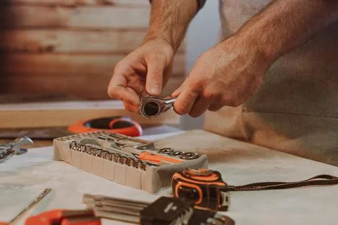 Close up of worker changing the nozzle for wrench Stock Photos