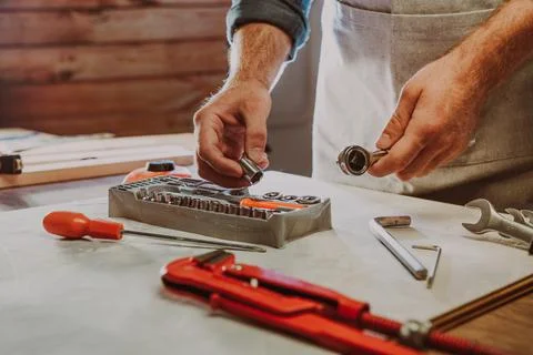 Close up of worker changing the nozzle for wrench Stock Photos