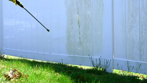 Close up of worker cleaning dirty white vinyl siding with high pressure power Stock Footage 180649358