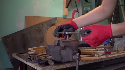 Close up worker cuts the damaged thread of a bolt clamped in a vise. Stock Footage 232045415