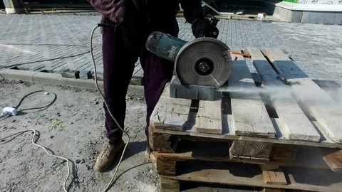 Close-up of worker cutting granite slab with grinder Video stock 96267830