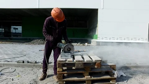 Close-up of worker cutting granite slab with grinder Video stock 96267839