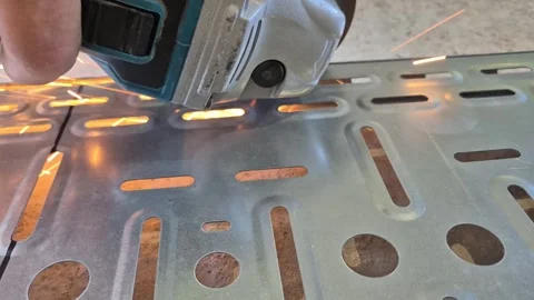 Close-up of worker cutting metal cable tray with angle grinder 動画素材 343755775