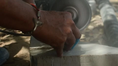 Close Up of Worker Cutting Stone with Angle Grinder and Protective Gloves Stock Footage 337865047