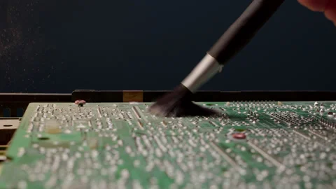 Close up worker in an electronics service center removes dust from an old large Stock Footage 219541807